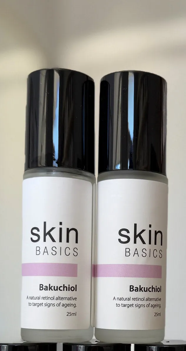 Two white airless bottles of a client's white label Bakuchiol with a lilac label band and black caps