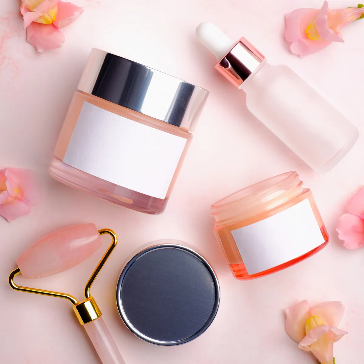 Skincare jars and a dropper bottle with blank labels, ready for a new brand's own label